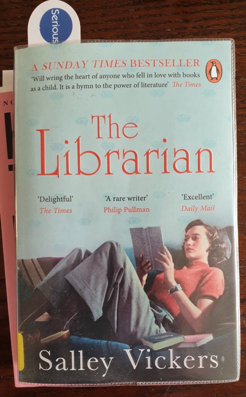 Book cover showing a lady lying on a sofa and reading